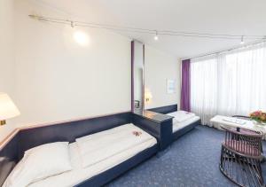 Postel nebo postele na pokoji v ubytování Hotel Mirage Düsseldorf-Neuss