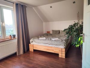 a bedroom with a bed with two books on it at Apartament Loft na Kaszubach - Laskowa Góra Bieszkowice in Bieszkowice