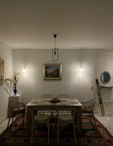a dining room with a table and chairs and lights at Ria's Home in Athens