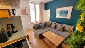 a living room with a couch and a table at le Savannah in Saint-Omer