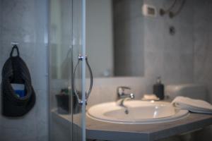 a bathroom with a sink and a glass shower at Hotel La Settima Luna in Savudrija +54 photos