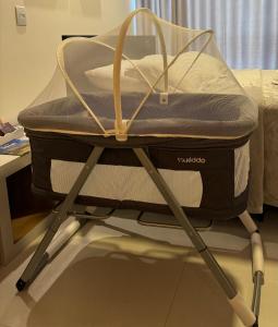 a suitcase sitting on top of a bed at Flat Home Business 401 Centro de Pomerode in Pomerode