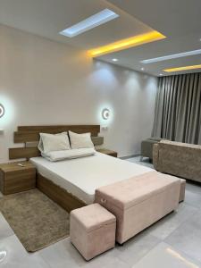 a bedroom with a large bed and a couch at OceanView Ndayane - Villa de luxe avec vue sur mer et piscine in Ndayane