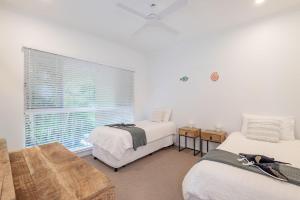 a bedroom with two beds and a window at 4-18 Peregian Esplanade, Peregian Beach QLD 4573 in Peregian Beach +19 photos