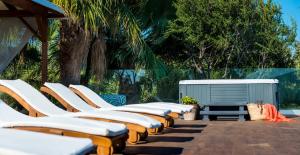 a row of chaise lounges are lined up at Erietta Aparthotel in Tsilivi