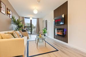a living room with a couch and a fireplace at City Centre Birmingham 1-Bed with WiFi and Parking in Birmingham