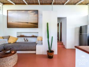 a living room with a couch and a table at Casa Mais Amor in Atins