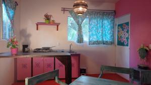 a kitchen with a table and two chairs in a room at Casa Vainilla Holbox Island in Holbox Island