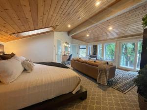 a large bedroom with a bed and a couch at Tyee Beach Oasis Bed and Breakfast in Nanoose Bay