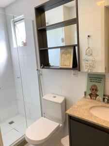 a bathroom with a toilet and a sink and a shower at o MELHOR DA PRAIA BRAVA !!! in Itajaí
