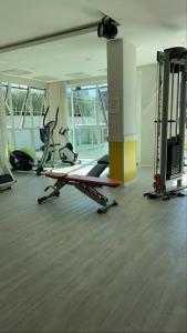 a gym with several tread machines in a room at o MELHOR DA PRAIA BRAVA !!! in Itajaí +8 photos
