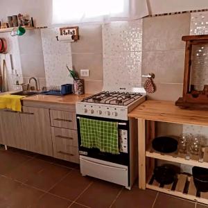 a kitchen with a stove and a counter top at El Rincón de Caro y Nico in Las Grutas