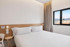 Postel nebo postele na pokoji v ubytování B&B HOTEL Viana do Castelo