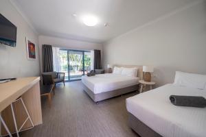 Postel nebo postele na pokoji v ubytování Woolgoolga Coast Motel