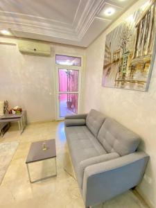 a living room with a couch and a table at Appartement de lux in Casablanca +15 photos