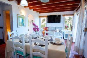 a dining room with a table and white chairs at Las Marinas in Ostende