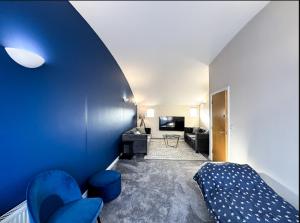a room with a bed and a living room at Suitely Museum Residence with roof terrace in Ipswich