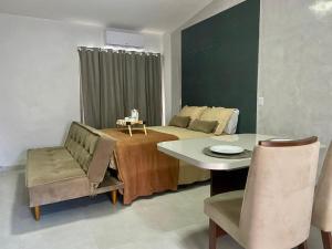 a room with a bed and a table and chairs at Loft Iron em capim macio in Natal