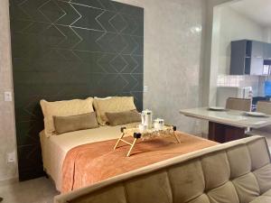 a bedroom with a bed with a table on it at Loft Iron em capim macio in Natal +28 photos