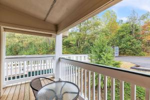 a porch with two chairs and a table at Grand Wood Suites - 3rd Floor Back Side Corner Penthouse Suite 308 in Nashville