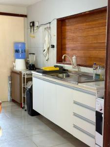 a kitchen with a sink and a counter top at Casa do Pescador - Praia do Maceió - Camocim - CE in Camocim +23 photos