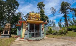 a small building with a gate in a park at The Green Lush in Pussellawa