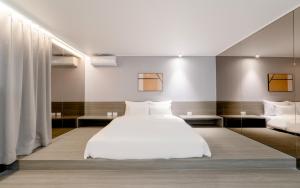 a bedroom with a white bed and two pillows at Anook Hotel Incheon Bupyeong in Incheon