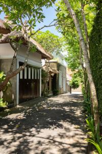 a road leading to a house with trees at Bali Ula Villa in Nusa Dua