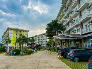 a parking lot with cars parked in front of buildings at ANIA CONDO STAY in Mactan