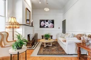 a living room with a white couch and a fireplace at Norwood Arthouse 7 Bedroom 7 Bathroom in Blackheath