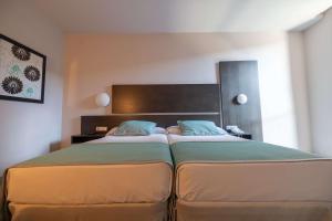 Postel nebo postele na pokoji v ubytování Hotel Ciudad de Ponferrada, Ascend Hotel Collection