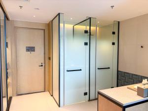 a bathroom with a glass elevator and a door at Four Points by Sheraton Datong Pingcheng in Datong