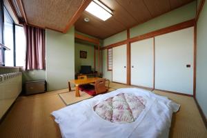 Postel nebo postele na pokoji v ubytování Hosonokan