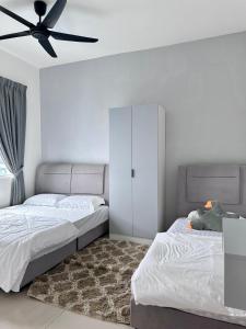 a bedroom with two beds and a ceiling fan at Leisure Home - 7pax Camping Theme in Kampong Lobok