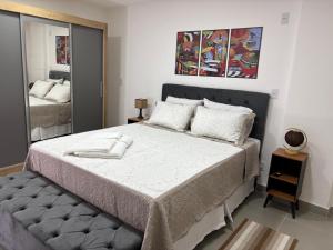 a bedroom with a large bed and a mirror at Studio próximo Museu do Amanhã in Rio de Janeiro +9 photos