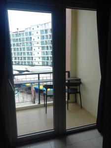 a view of a balcony from a room with a window at Dania in Pattaya Central