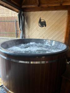 a large wooden tub with a cat sign on the wall at U Topora z Jacuzzi - 80m do stacji narciarskiej in Małe Ciche +131 photos