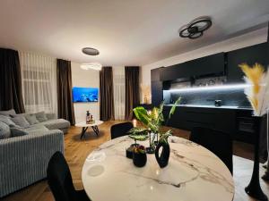 a living room with a table and a couch at Newly Renovated 1BR in Kaunas Downtown Central Location Fast WiFi in Kaunas