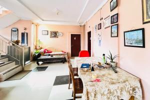 a room with a table and a living room at RedDoorz at Serdika Pavilion Berastagi in Berastagi