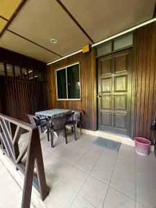 a patio with a table and chairs and a door at The Reef Chalet Perhentian Island - Bluestar in Perhentian Island