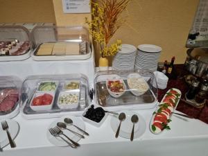 a table topped with trays of food on a table at Hotel Reuterhof in Darmstadt