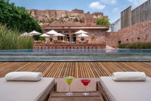 two glasses of wine sitting on a table on a patio at RAAS Jodhpur in Jodhpur