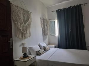 Ένα ή περισσότερα κρεβάτια σε δωμάτιο στο Le Dhow