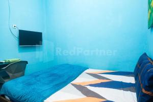 TV a/nebo společenská místnost v ubytování Anane Malioboro Homestay RedPartner