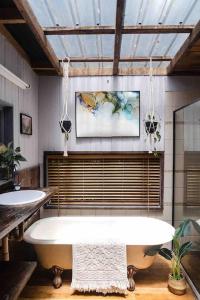 a bathroom with two sinks and a large tub at Ananda Eco House - Eco Rainforest Retreat in Montville