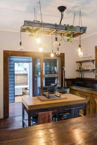 a kitchen with a wooden table in a room at Ananda Eco House - Eco Rainforest Retreat in Montville