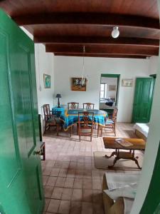 a living room with a blue table and chairs at The Arniston Kliphuis circa 1880 in Arniston