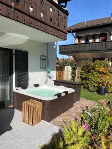 a hot tub in the backyard of a house at Engelsherz in Mittenwald