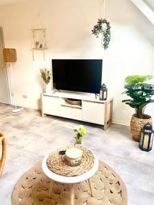 a living room with a tv and a coffee table at Cottbus-Apartments - Beige Apartment I privat I Wifi I Küche in Cottbus +24 photos