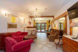 a living room with a red couch and chairs at Porto in Karwia